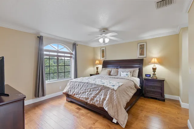 a bedroom with a bed and wooden floor