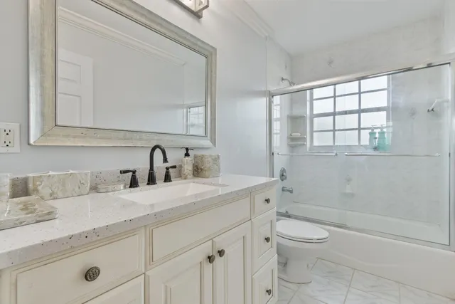 an aerial view of a house with pool garden and trees