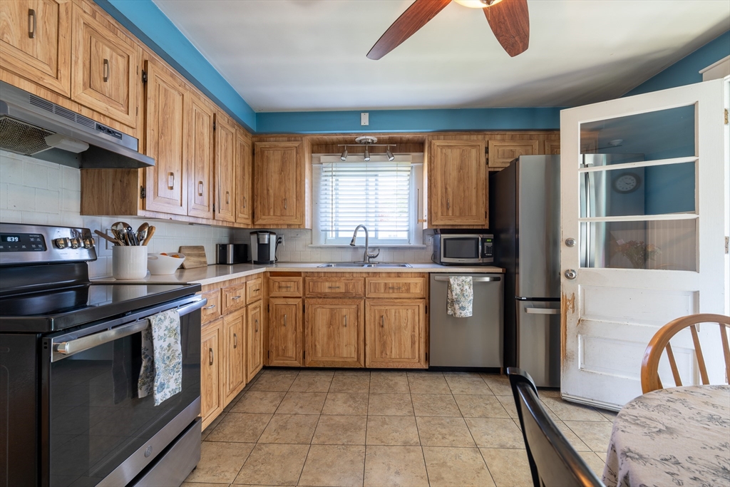 110 James M Beardsworth Road Tiverton, RI 02878 - Photo 16 of 26 a kitchen with stainless steel appliances granite countertop a stove a sink and a refrigerator