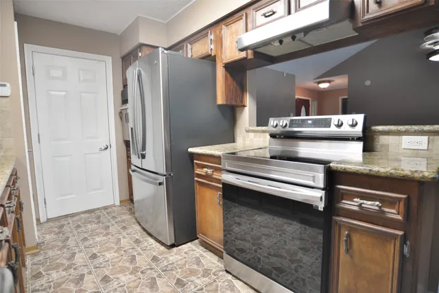 a kitchen with a refrigerator and a sink