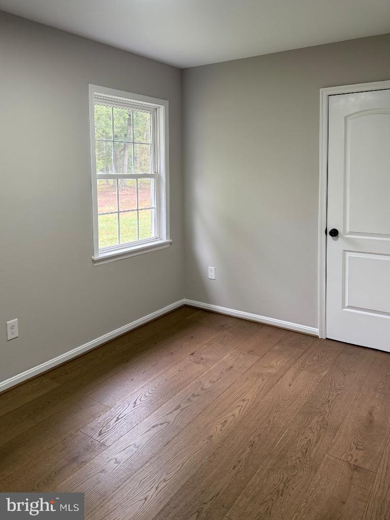12713 Foxtrot Road Bealeton, VA 22712 - Photo 13 of 19 an empty room with wooden floor and windows