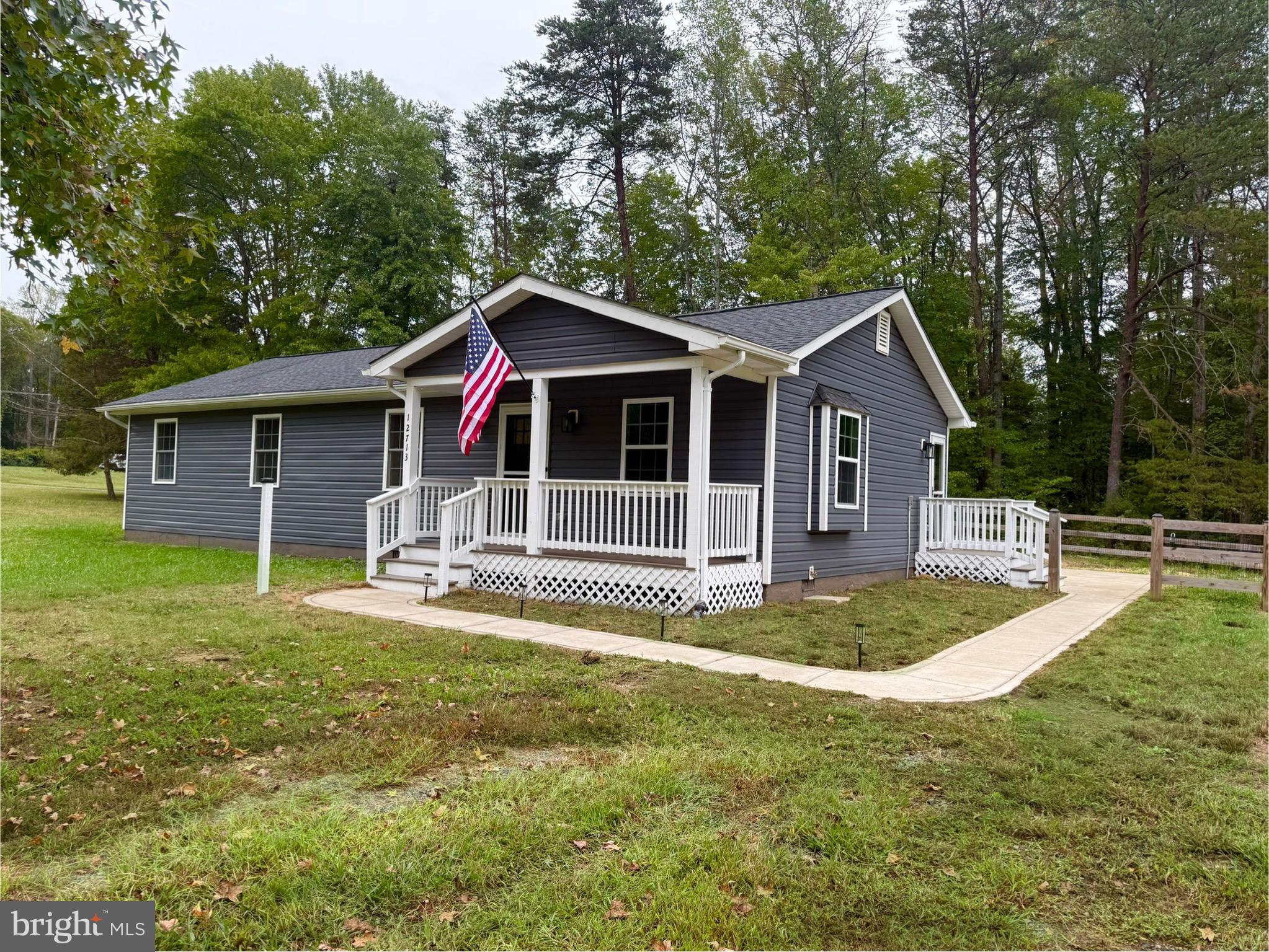 12713 Foxtrot Road Bealeton, VA 22712 - Photo 15 of 19 a view of a house with a yard patio and swimming pool