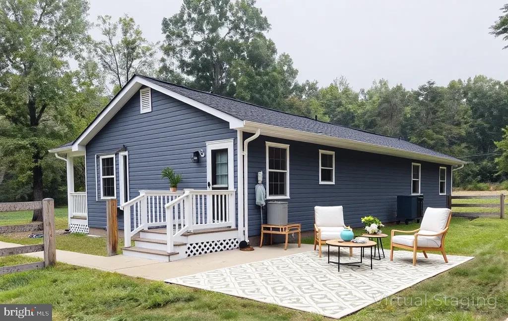 12713 Foxtrot Road Bealeton, VA 22712 - Photo 2 of 19 a view of a house with a patio and a garden