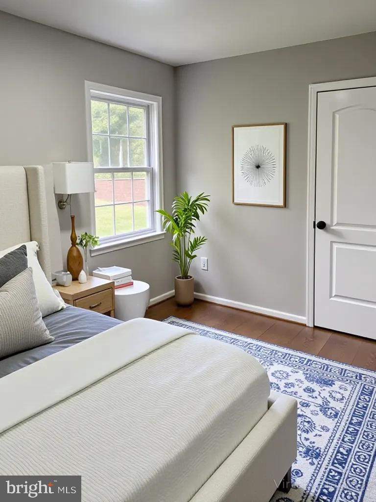 12713 Foxtrot Road Bealeton, VA 22712 - Photo 4 of 19 a bedroom with a bed and wooden floor