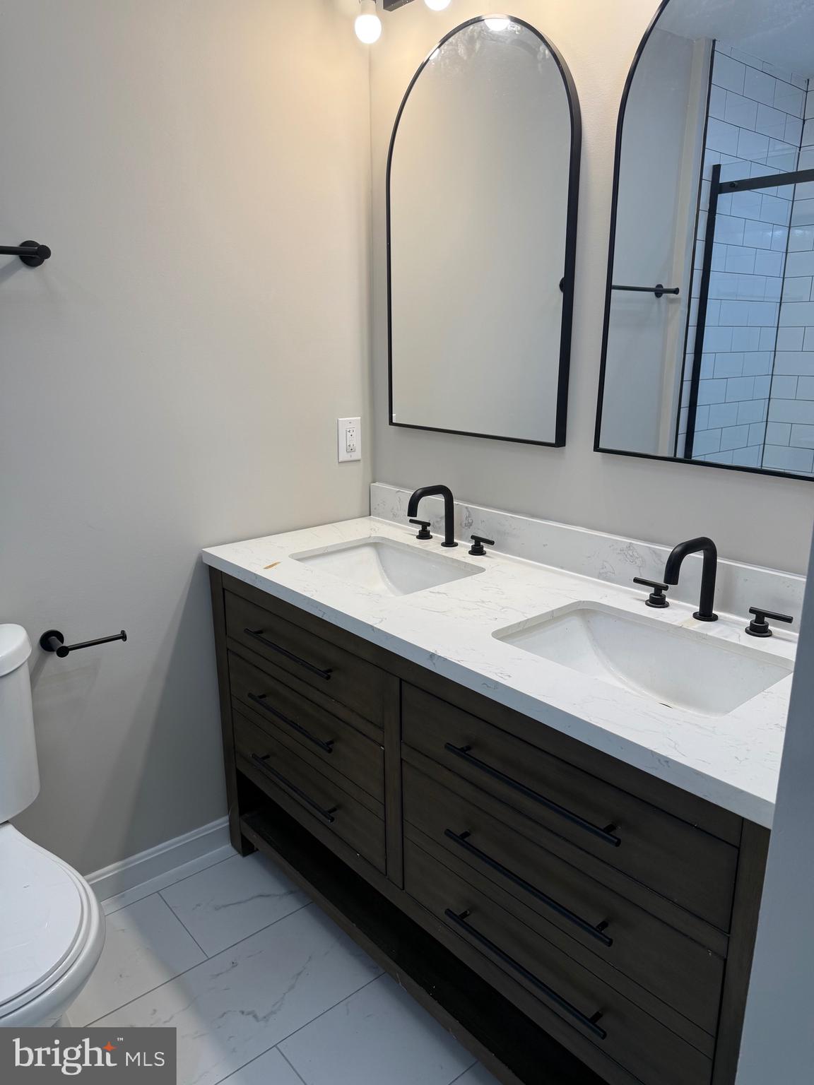 12713 Foxtrot Road Bealeton, VA 22712 - Photo 7 of 19 a bathroom with a toilet sink and mirror