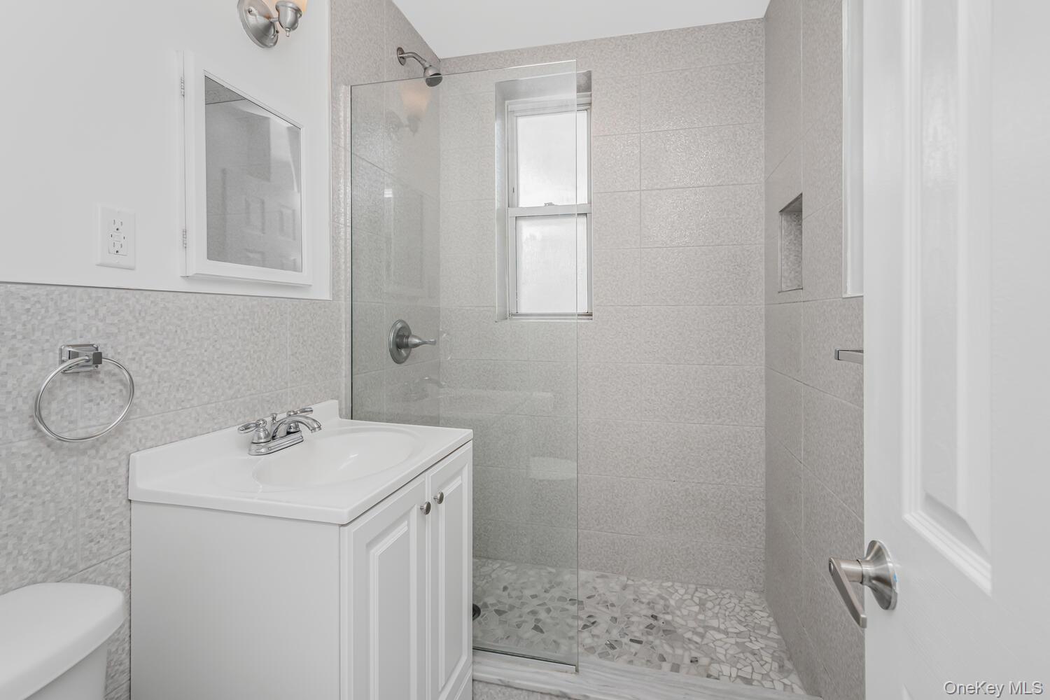 4320 Van Cortlandt Park East, Unit 5A Bronx, NY 10470 - Photo 11 of 15 Luxurious New Hall bathroom with all new Fixtures along with a Custom Stand in shower.