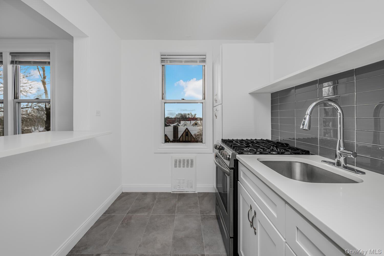4320 Van Cortlandt Park East, Unit 5A Bronx, NY 10470 - Photo 5 of 15 Beautiful Glass Backsplash along with Quartz Countertop