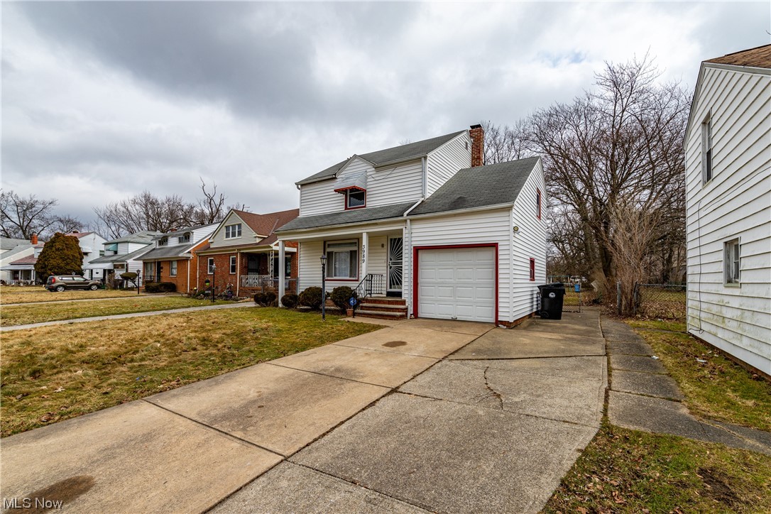 3989 Strandhill Road Cleveland, OH 44128 - Photo 2 of 13 View of front of property with covered porch, a front yard, and a garage