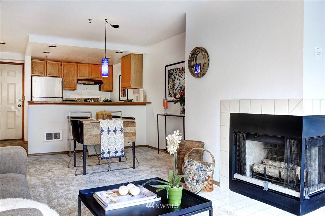 3901 Fremont Avenue North, Unit 206 Seattle, WA 98103 - Photo 1 of 15 a living room with furniture and a fireplace
