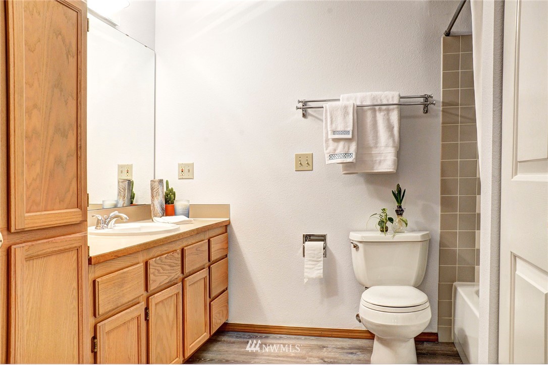 3901 Fremont Avenue North, Unit 206 Seattle, WA 98103 - Photo 8 of 15 a bathroom with a sink a toilet and a mirror