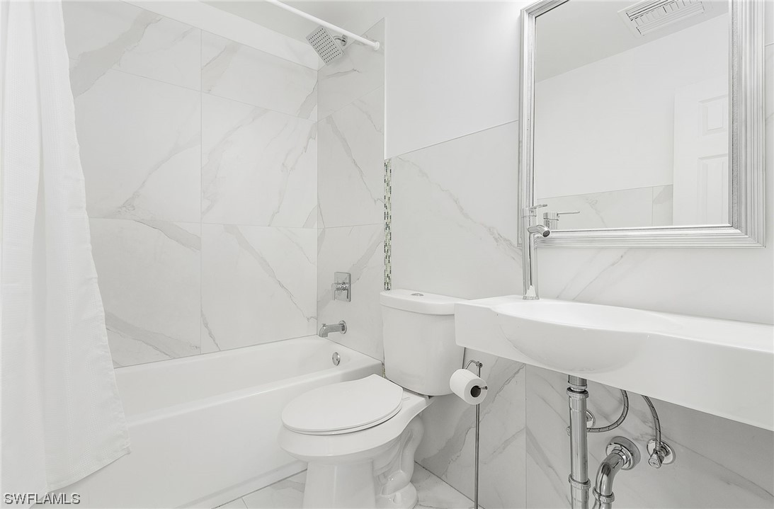 14230 Robert Road Bokeelia, FL 33922 - Photo 12 of 22 a bathroom with a sink a toilet and shower