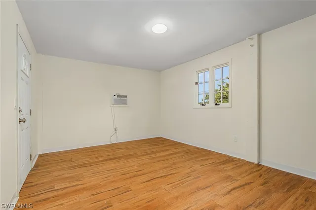 a bedroom with a bed and painting on the wall