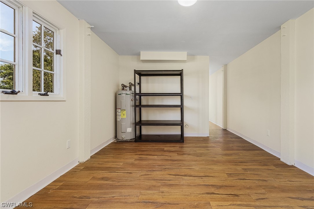 14230 Robert Road Bokeelia, FL 33922 - Photo 16 of 22 a view of a room with a wooden floor