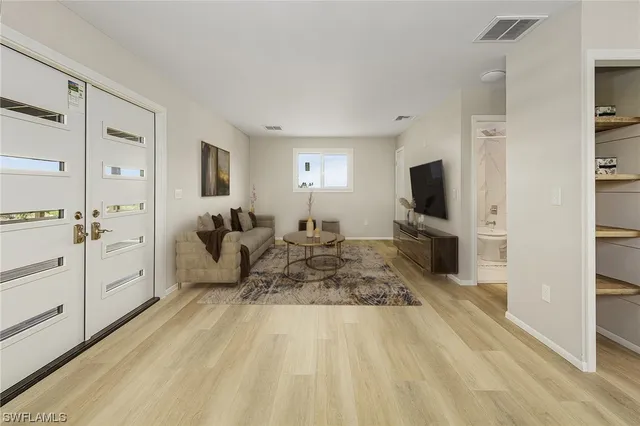 a living room with furniture and a flat screen tv