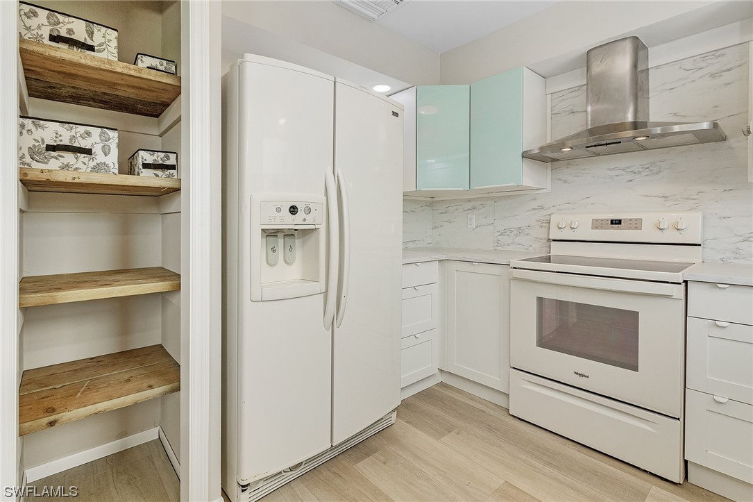 14230 Robert Road Bokeelia, FL 33922 - Photo 10 of 22 a kitchen with cabinets and appliances