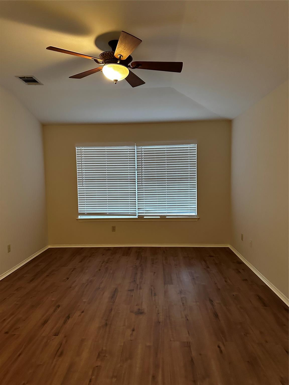 8007 Bounty Trail Austin, TX 78749 - Photo 19 of 32 Wood plank flooring and a ceiling fan provide comfort in this generously sized room.