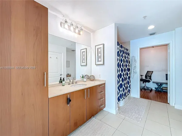a en suite bathroom with a sink a mirror and a shower