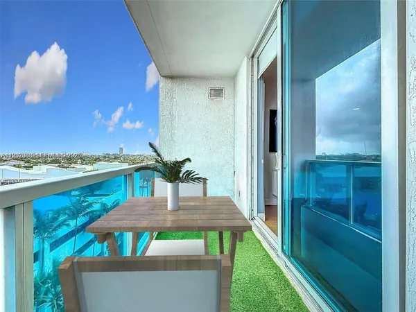 a view of a balcony with furniture and front door