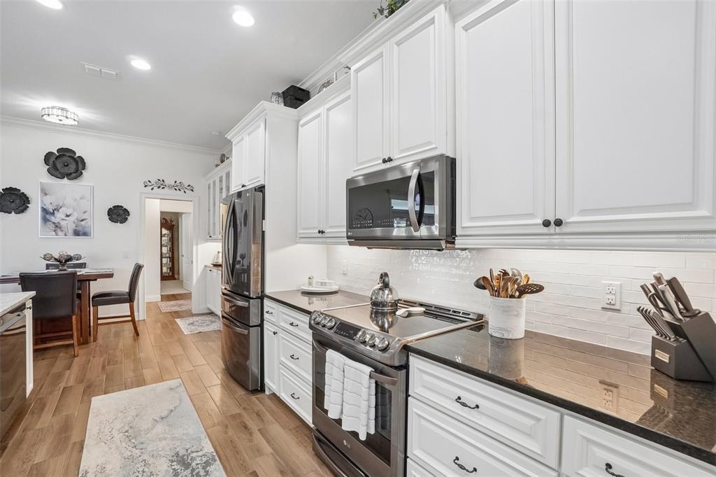 3934 Connersville Road Bartow, FL 33830 - Photo 23 of 81 a kitchen with stainless steel appliances a sink stove and cabinets