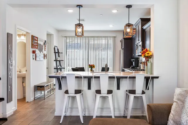 a large kitchen with a table and chairs