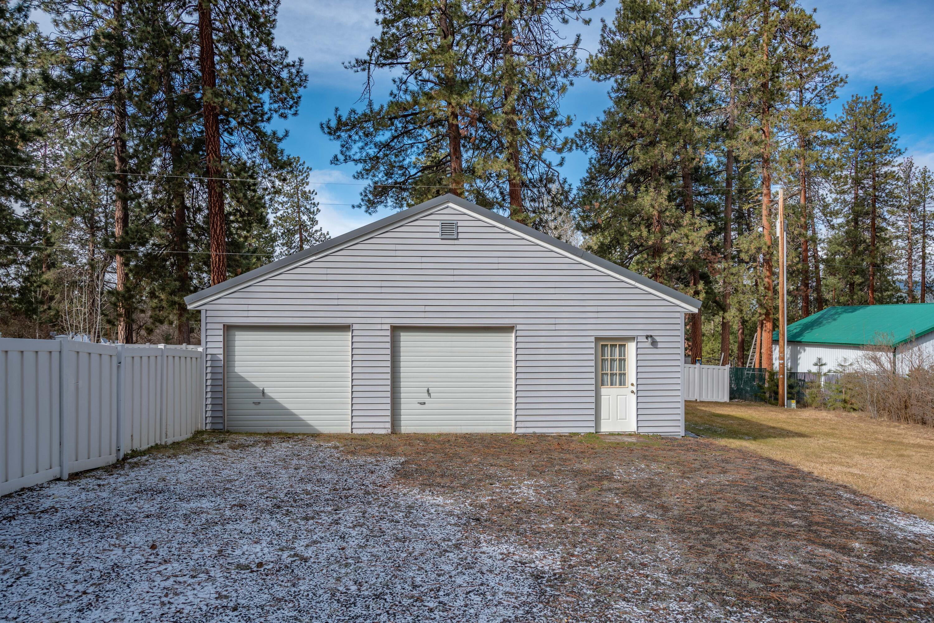 138722 Rhododendron Street Gilchrist, OR 97737 - Photo 6 of 36 a view of garage yard and large tree
