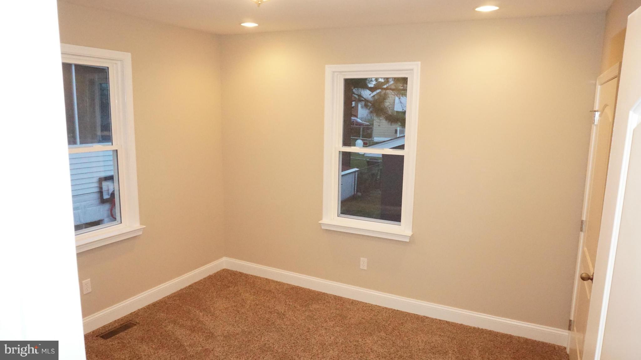 6922 Sollers Point Road Baltimore, MD 21222 - Photo 15 of 30 a view of an empty room with closet and a window