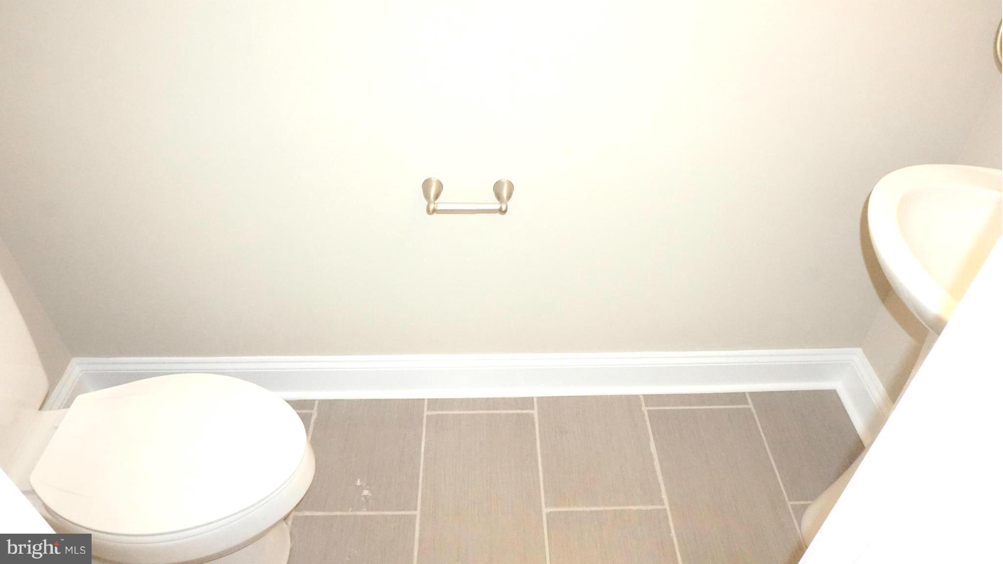 6922 Sollers Point Road Baltimore, MD 21222 - Photo 20 of 30 a bathroom with a sink and a mirror