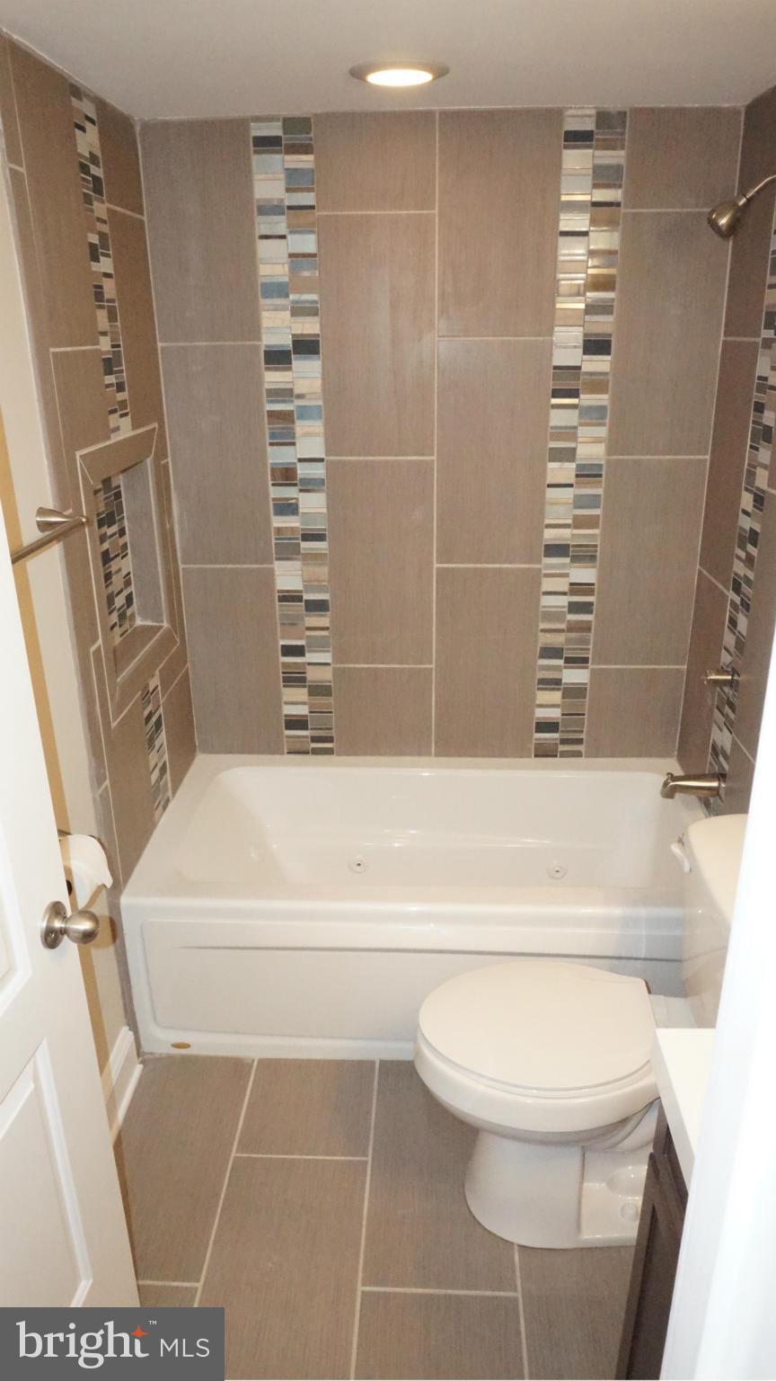 6922 Sollers Point Road Baltimore, MD 21222 - Photo 7 of 30 a bathroom with a toilet and a shower