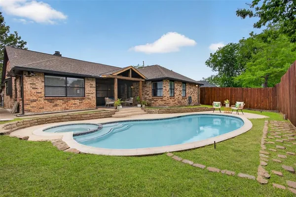 a view of a house with swimming pool and a yard