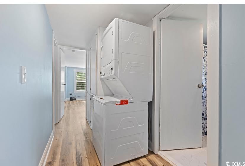 1044 Levi Street Manning, SC 29102 - Photo 11 of 26 Laundry area with stacked washer / drying machine, light wood-style floors, and baseboards