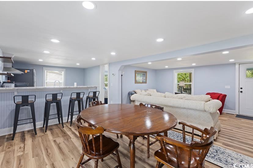 1044 Levi Street Manning, SC 29102 - Photo 8 of 26 Dining room with light wood finished floors, recessed lighting, plenty of natural light, and bar