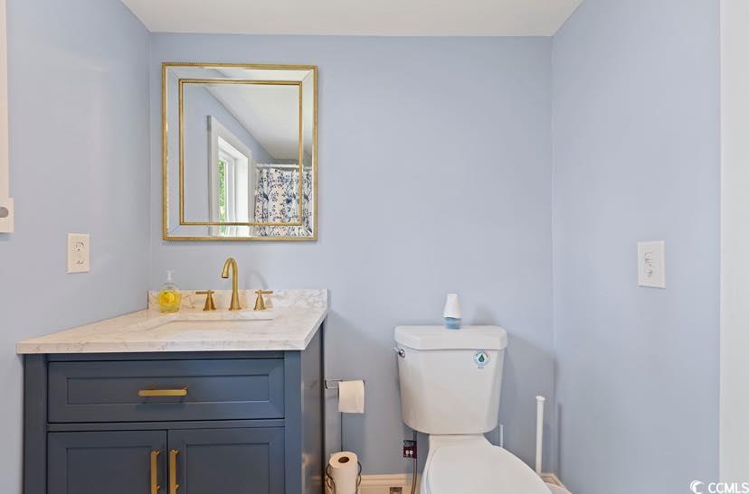 1044 Levi Street Manning, SC 29102 - Photo 9 of 26 Full bathroom featuring vanity, toilet, and baseboards