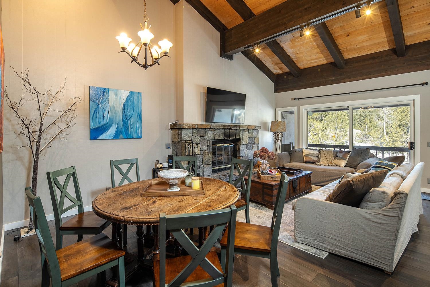 a living room with fireplace furniture and a large window