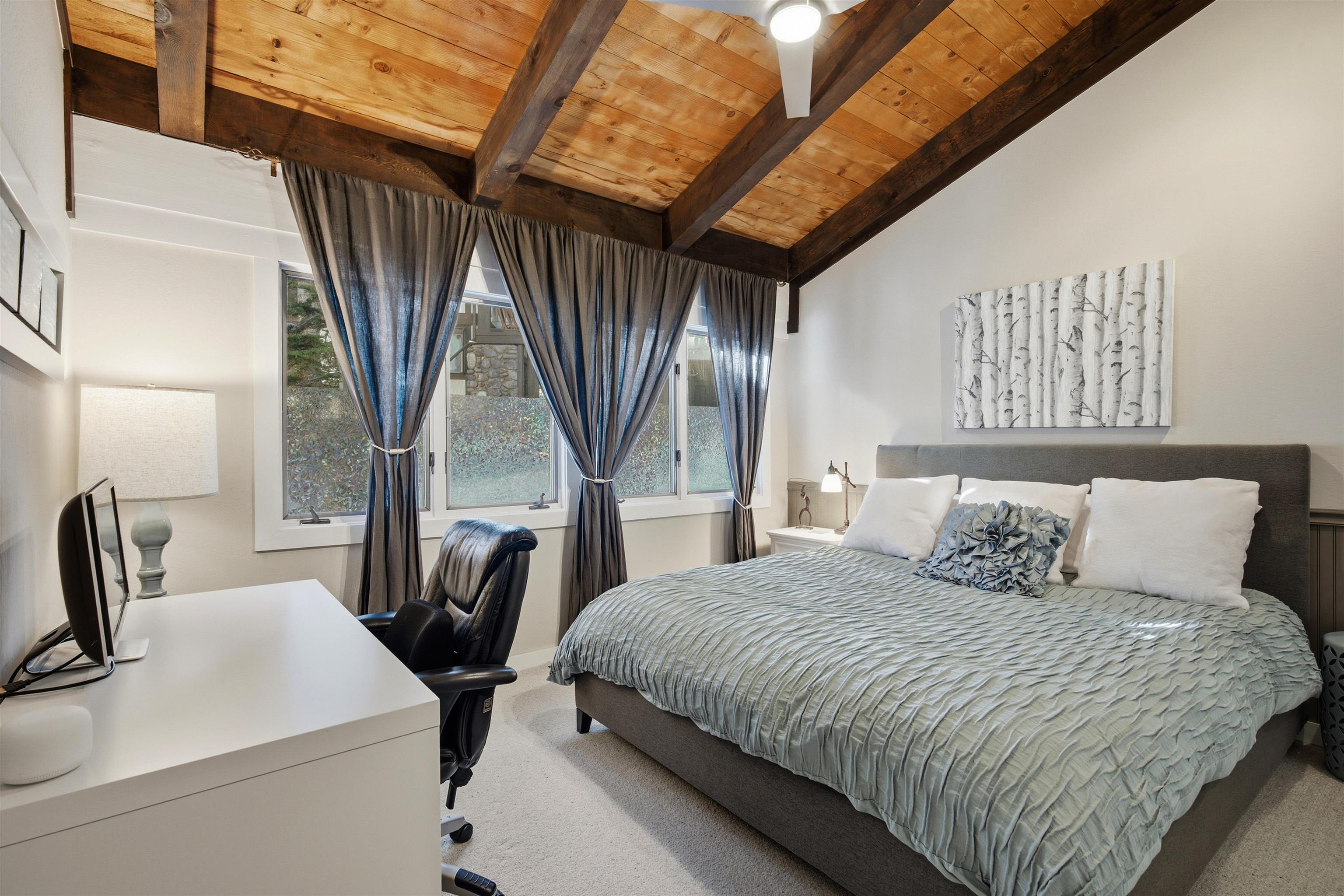 227 Olympic Vly Road, Unit 13 Olympic Valley, CA 96146 - Photo 18 of 28 a bedroom with a bed next to a large window with the outer view