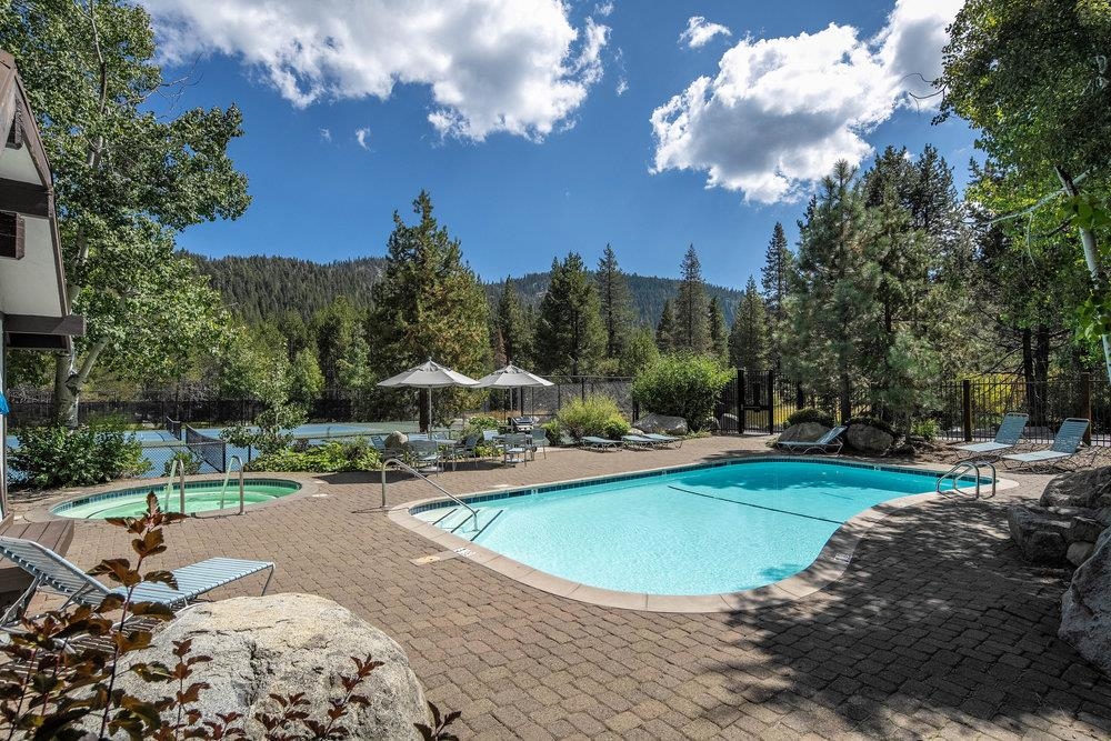 227 Olympic Vly Road, Unit 13 Olympic Valley, CA 96146 - Photo 25 of 28 a view of a swimming pool and lounge chairs