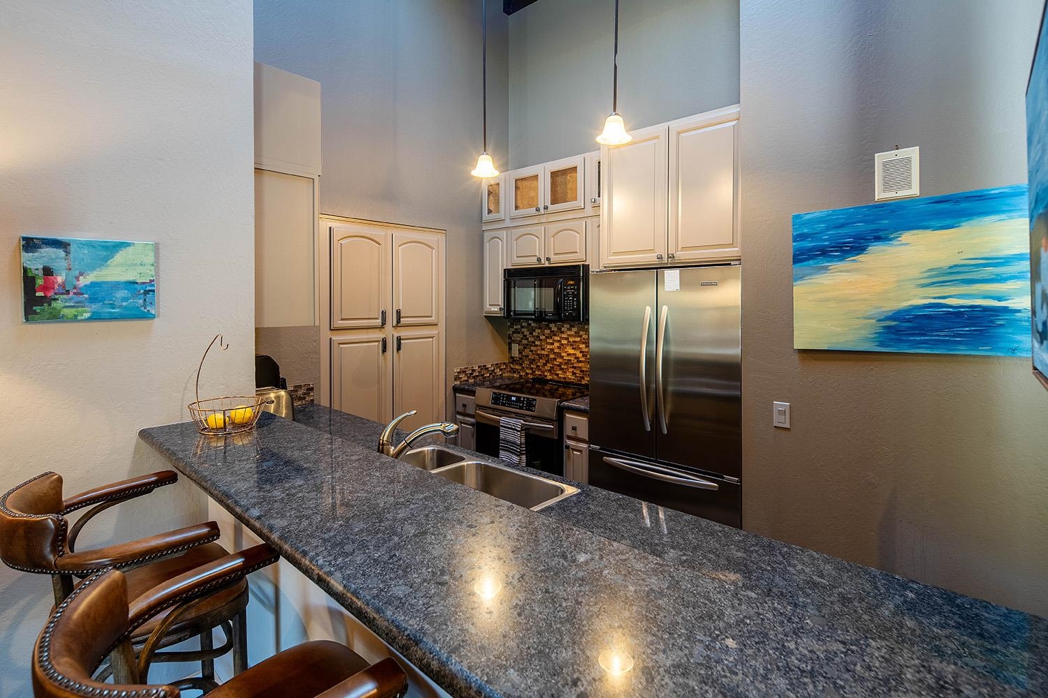 227 Olympic Vly Road, Unit 13 Olympic Valley, CA 96146 - Photo 10 of 28 a kitchen with kitchen island a counter top space cabinets and stainless steel appliances