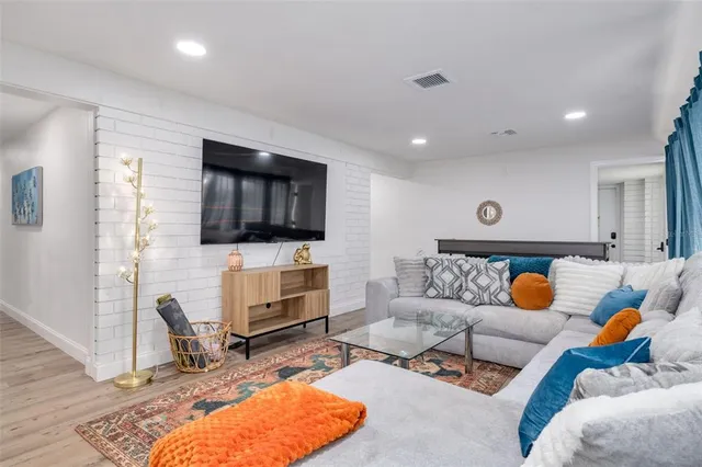 a view of a dining room with furniture and a chandelier