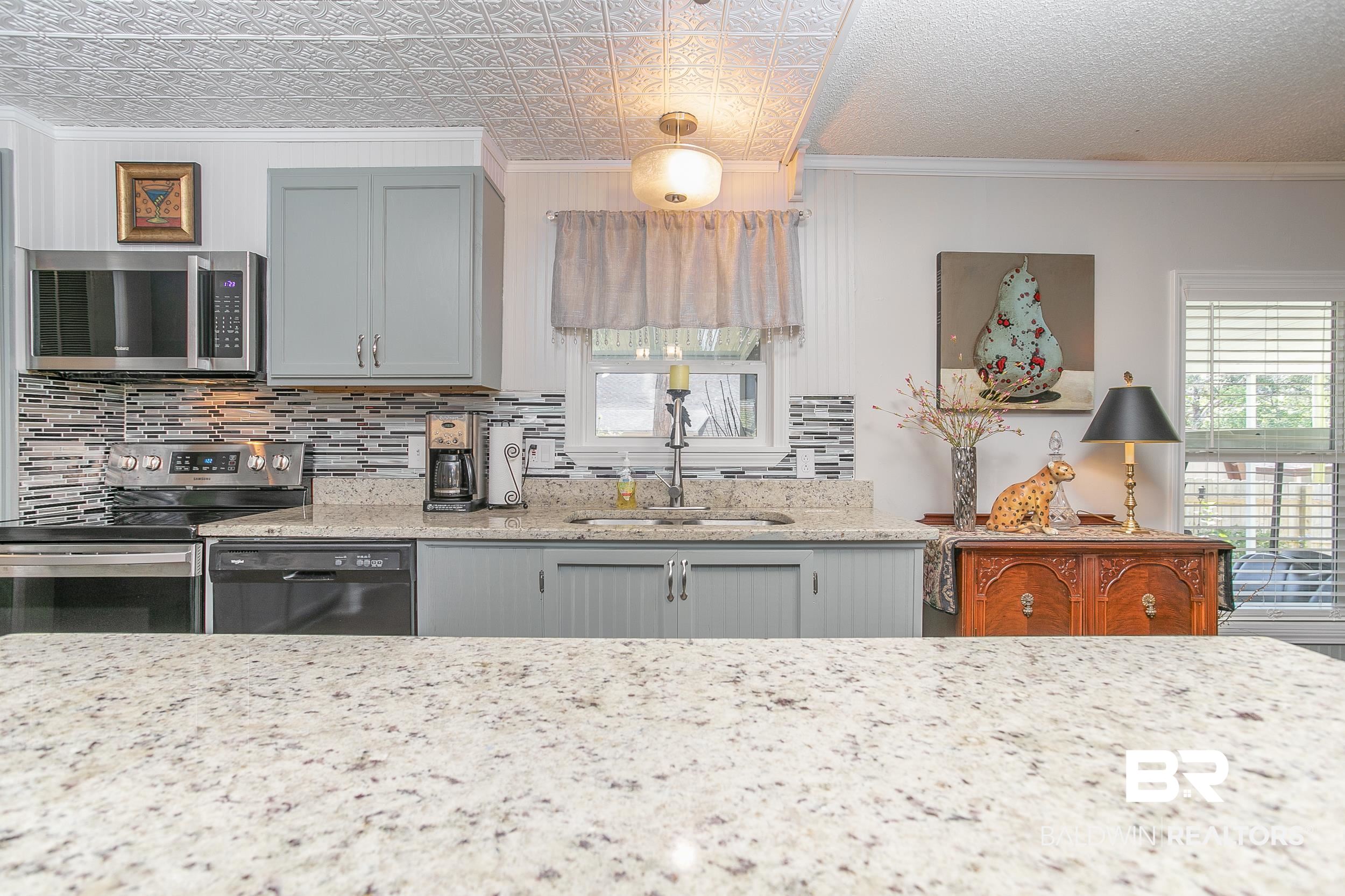 1652 Del Rey Drive Lillian, AL 36549 - Photo 8 of 50 Countertops of granite and floors of vinyl plank.