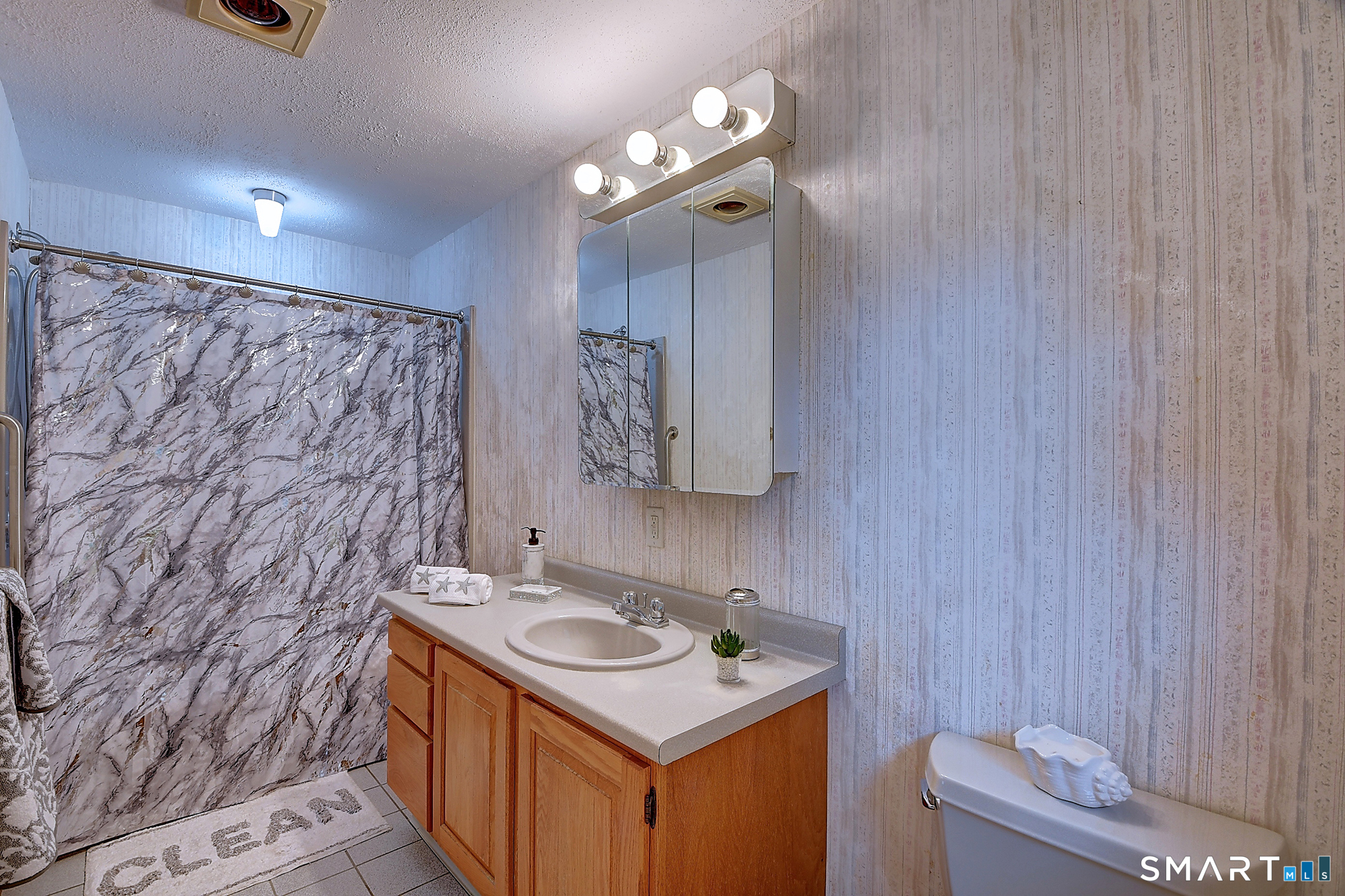 80 Grist Mill Road Wethersfield, CT 06109 - Photo 28 of 40 a bathroom with a sink and a mirror