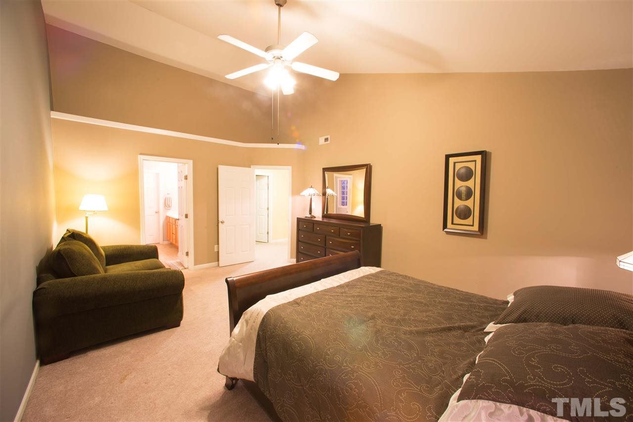 3545 Sunbright Lane Raleigh, NC 27610 - Photo 12 of 25 a bedroom with a bed and couch