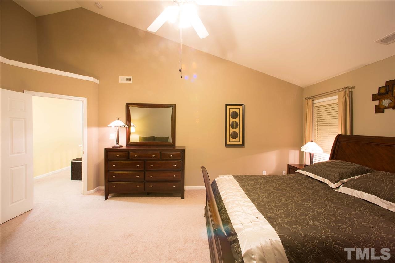 3545 Sunbright Lane Raleigh, NC 27610 - Photo 13 of 25 a bedroom with a bed and a dresser