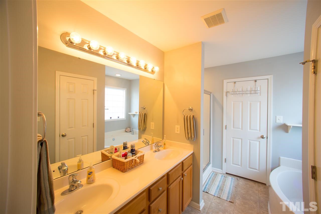3545 Sunbright Lane Raleigh, NC 27610 - Photo 14 of 25 a bathroom with a sink and a mirror