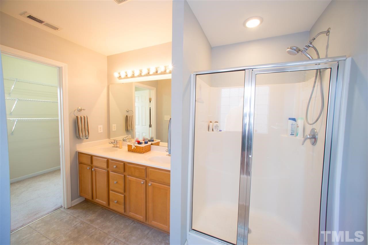 3545 Sunbright Lane Raleigh, NC 27610 - Photo 15 of 25 a bathroom with a double vanity sink mirror and shower