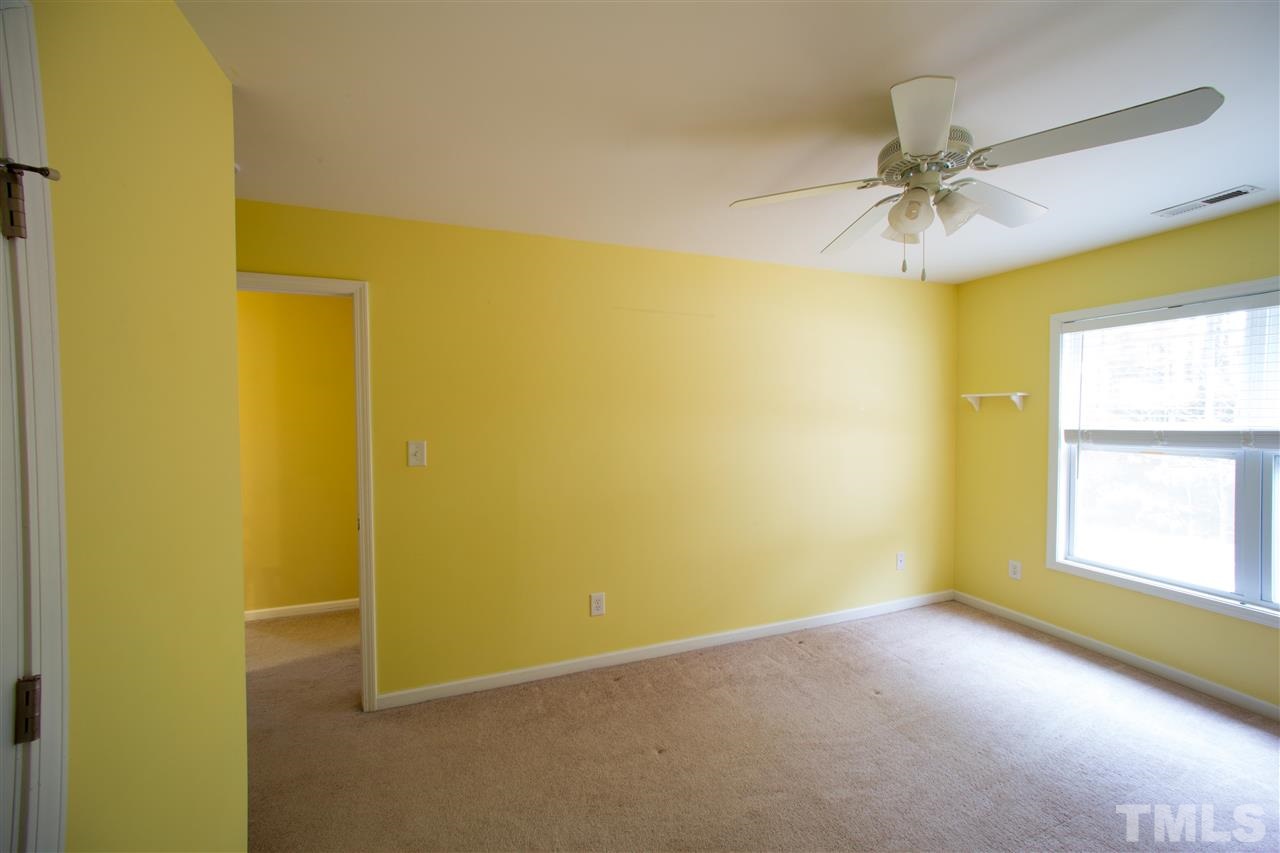 3545 Sunbright Lane Raleigh, NC 27610 - Photo 17 of 25 an empty room with a window and a ceiling fan
