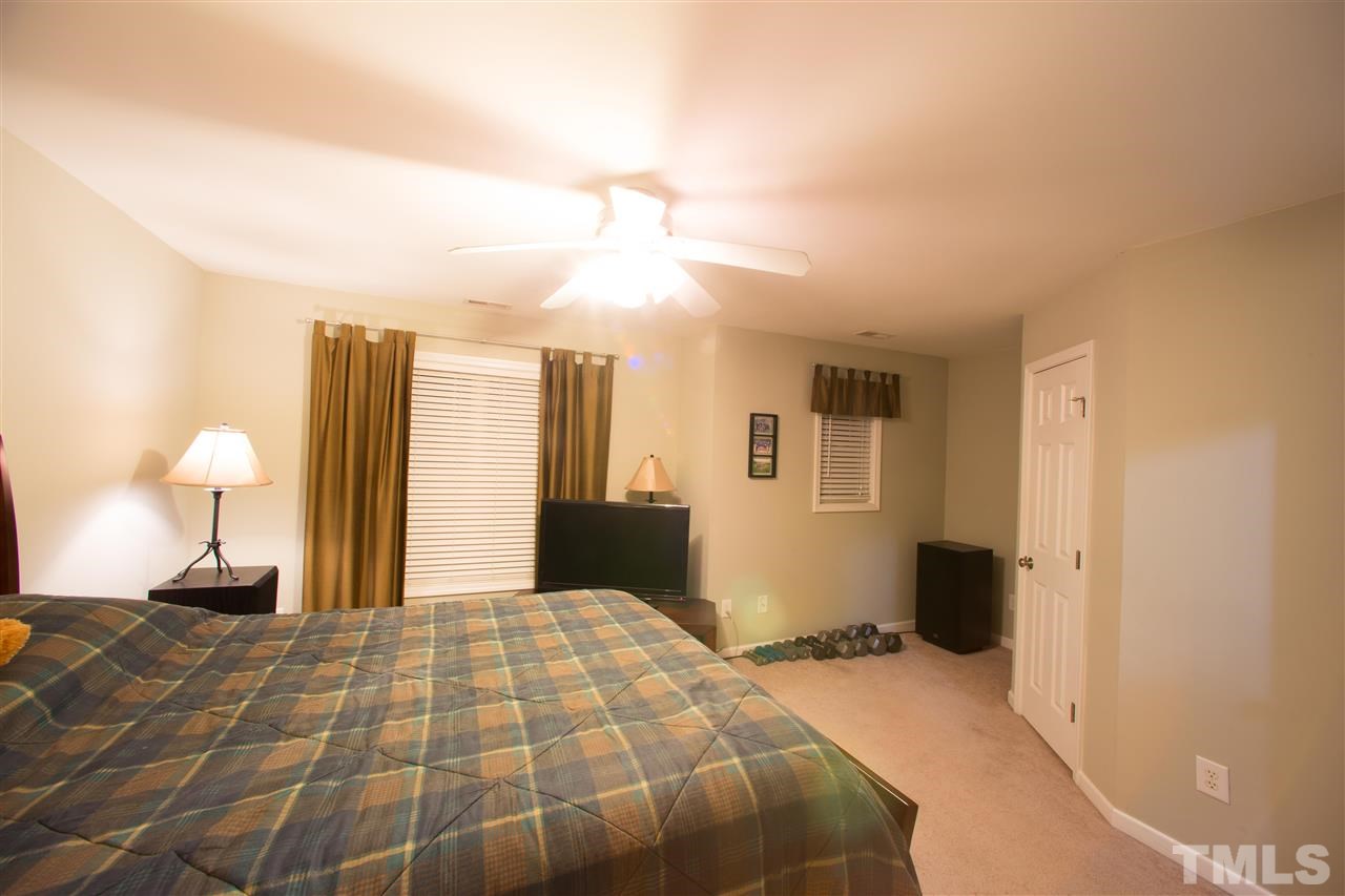 3545 Sunbright Lane Raleigh, NC 27610 - Photo 19 of 25 a bedroom with a bed and a lamp