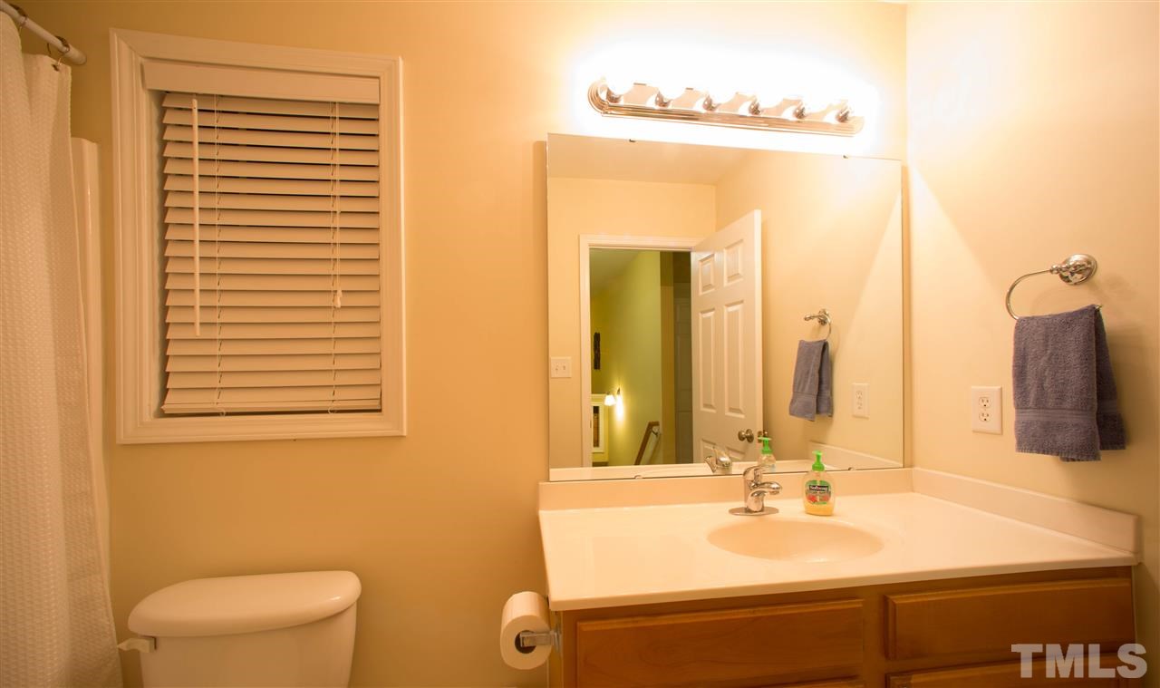 3545 Sunbright Lane Raleigh, NC 27610 - Photo 21 of 25 a bathroom with a sink and a mirror