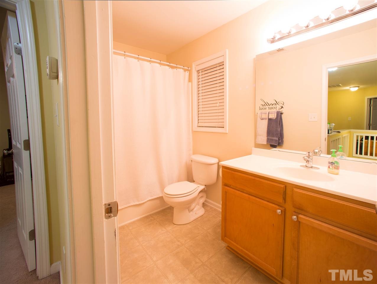 3545 Sunbright Lane Raleigh, NC 27610 - Photo 22 of 25 a bathroom with a toilet a sink and a window