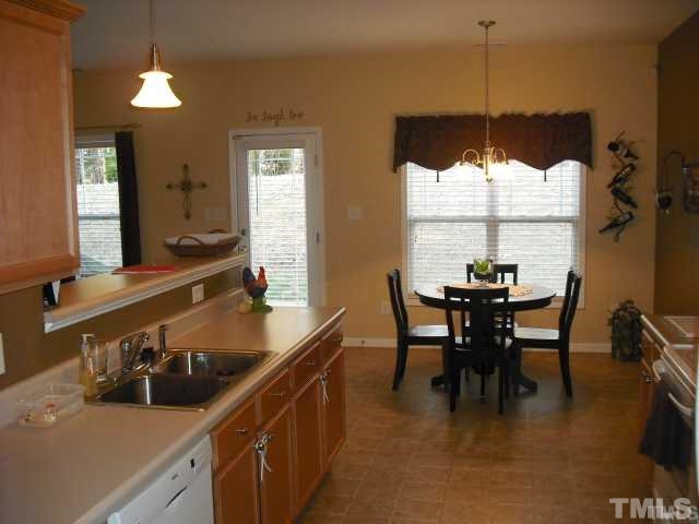 3545 Sunbright Lane Raleigh, NC 27610 - Photo 4 of 25 a kitchen with a dining table and chairs