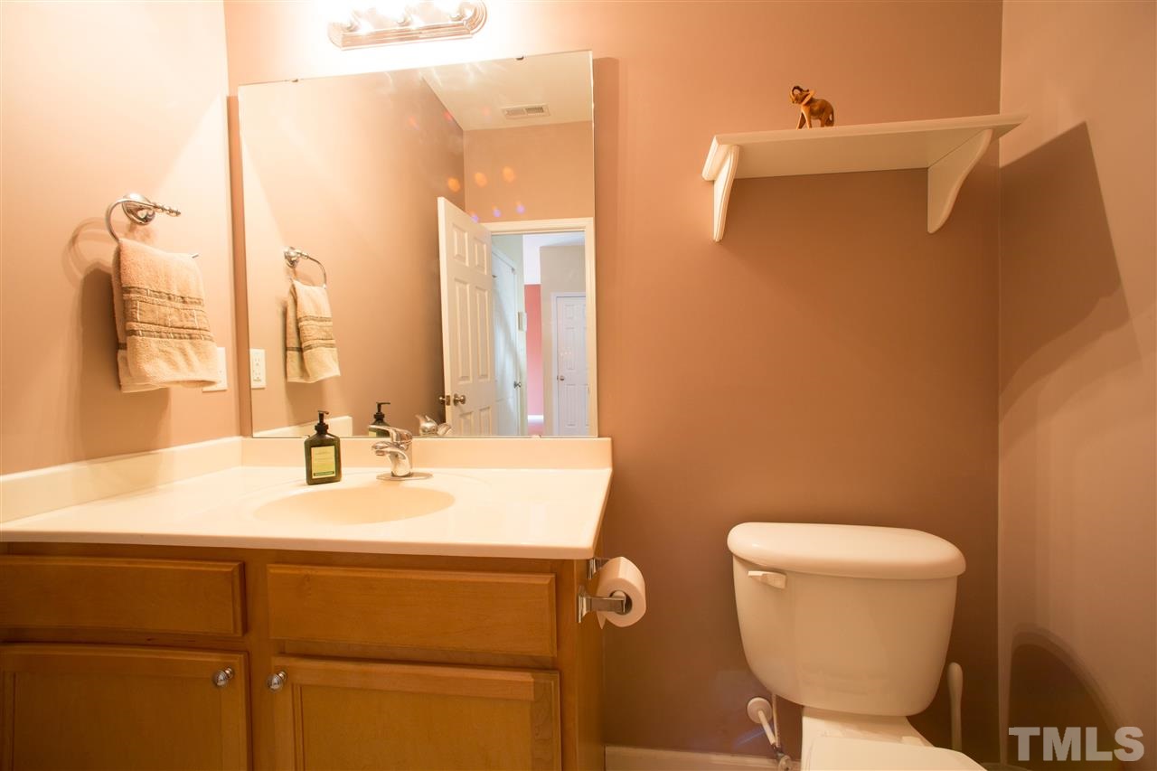 3545 Sunbright Lane Raleigh, NC 27610 - Photo 8 of 25 a bathroom with a toilet sink and mirror