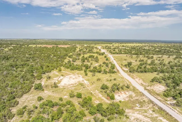 a view of a yard with an ocean and trees